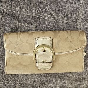 Vintage Coach Soho Signature Flap Buckle Snap Bifold Wallet in gold metallic.